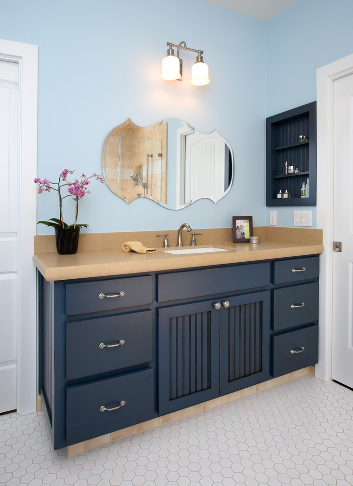 Inspiration for an eclectic bathroom in San Francisco with an undermount sink, recessed-panel cabinets, blue cabinets, white tile and blue walls.