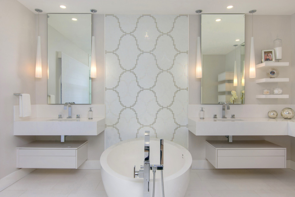 This is an example of a medium sized contemporary ensuite bathroom in San Diego with flat-panel cabinets, white cabinets, a freestanding bath, a corner shower, a one-piece toilet, white tiles, glass tiles, grey walls, marble flooring, a submerged sink, marble worktops, white floors, a hinged door, white worktops, an enclosed toilet, double sinks and a floating vanity unit.