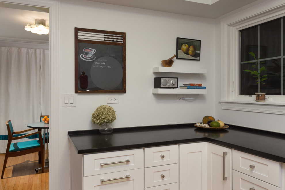 Enclosed kitchen - mid-sized transitional u-shaped medium tone wood floor enclosed kitchen idea in Chicago with a double-bowl sink, white cabinets, quartzite countertops, gray backsplash, subway tile backsplash, stainless steel appliances, no island and shaker cabinets