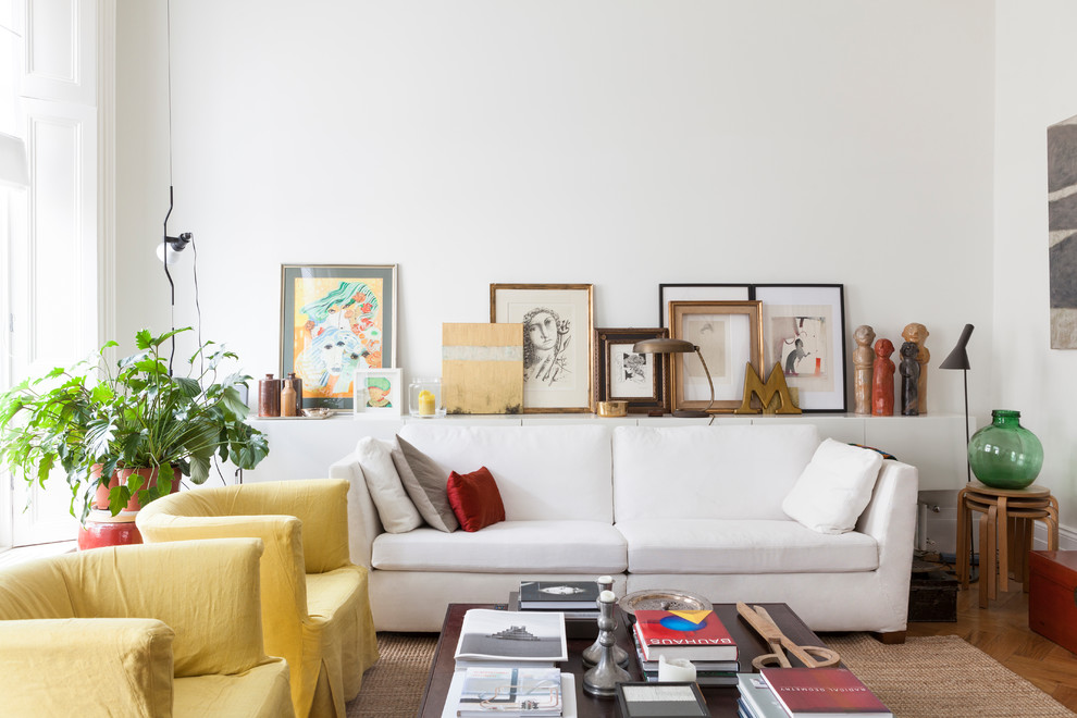 Scandinavian enclosed living room in London with white walls, medium hardwood floors and brown floor.