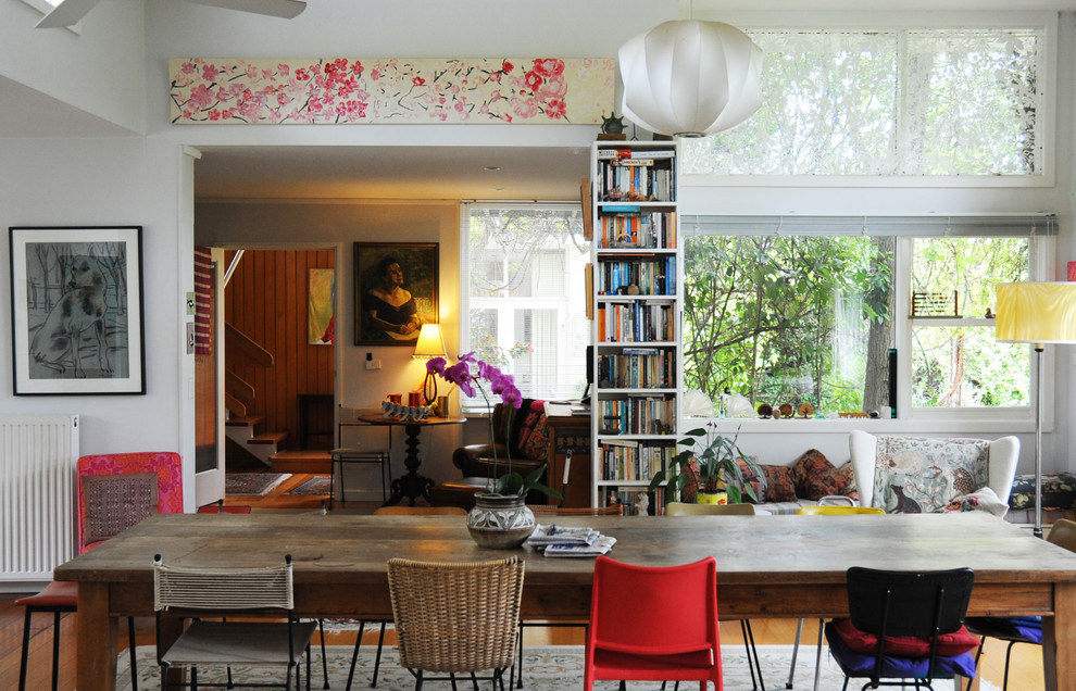Photo of an eclectic dining room in Sydney with white walls.