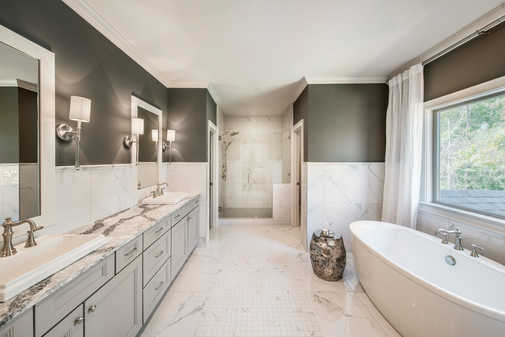 Design ideas for a traditional master bathroom in Atlanta with recessed-panel cabinets, grey cabinets, a freestanding tub, an alcove shower, black and white tile, grey walls, a drop-in sink and white floor.