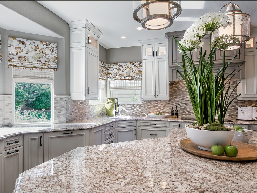 Eat-in kitchen - mid-sized transitional l-shaped dark wood floor and brown floor eat-in kitchen idea in Denver with an undermount sink, recessed-panel cabinets, beige cabinets, granite countertops, multicolored backsplash, mosaic tile backsplash, stainless steel appliances and an island