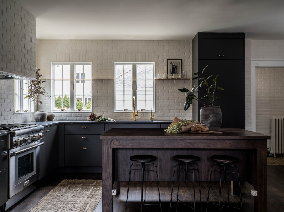 Inspiration for a mid-sized transitional u-shaped kitchen in Providence with an undermount sink, flat-panel cabinets, blue cabinets, soapstone benchtops, with island and brown floor.
