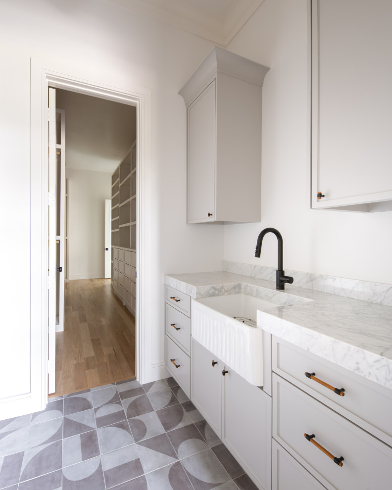 This is an example of a transitional laundry room in Dallas.