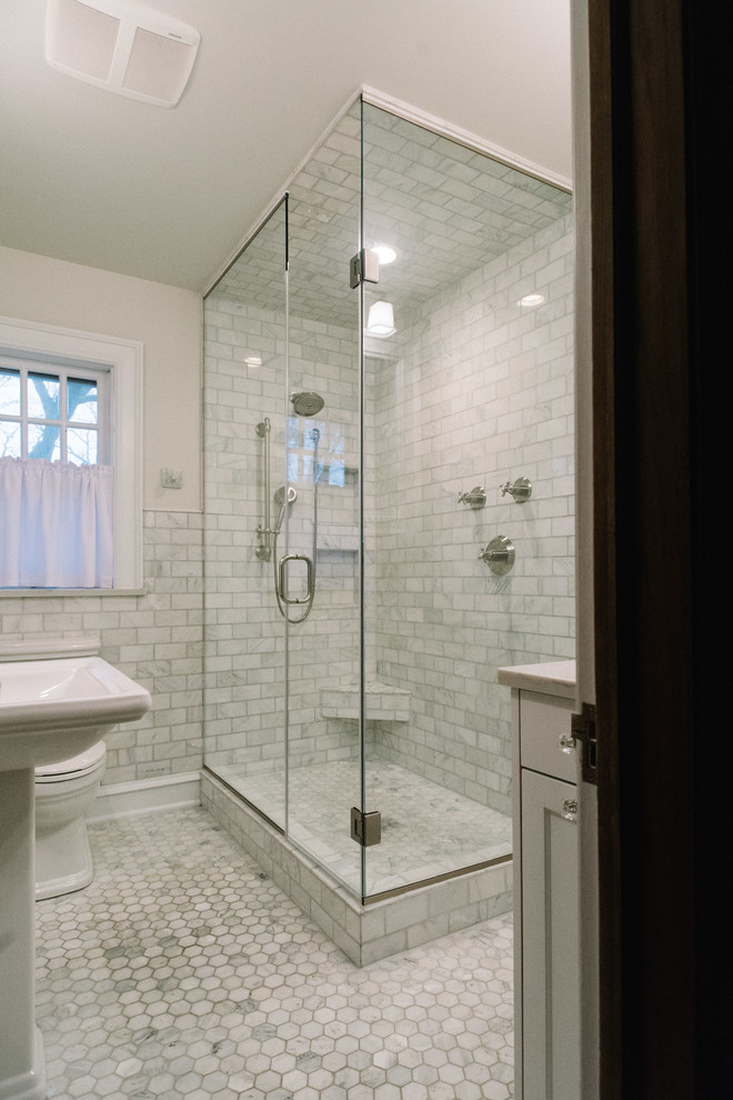 Double shower - mid-sized transitional 3/4 subway tile and gray tile marble floor and gray floor double shower idea with a two-piece toilet, a pedestal sink, quartz countertops, a hinged shower door and gray walls