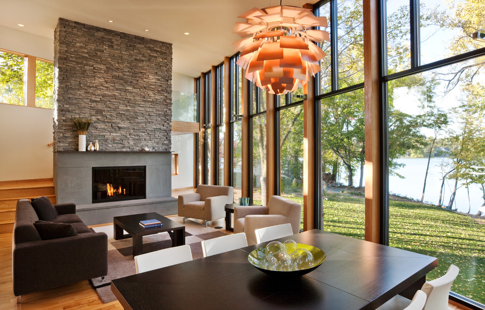 This is an example of a modern living room in Minneapolis with a concrete fireplace surround.