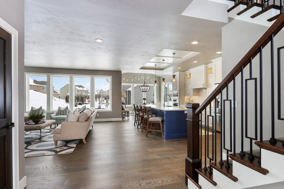 Large transitional medium tone wood floor foyer photo with gray walls