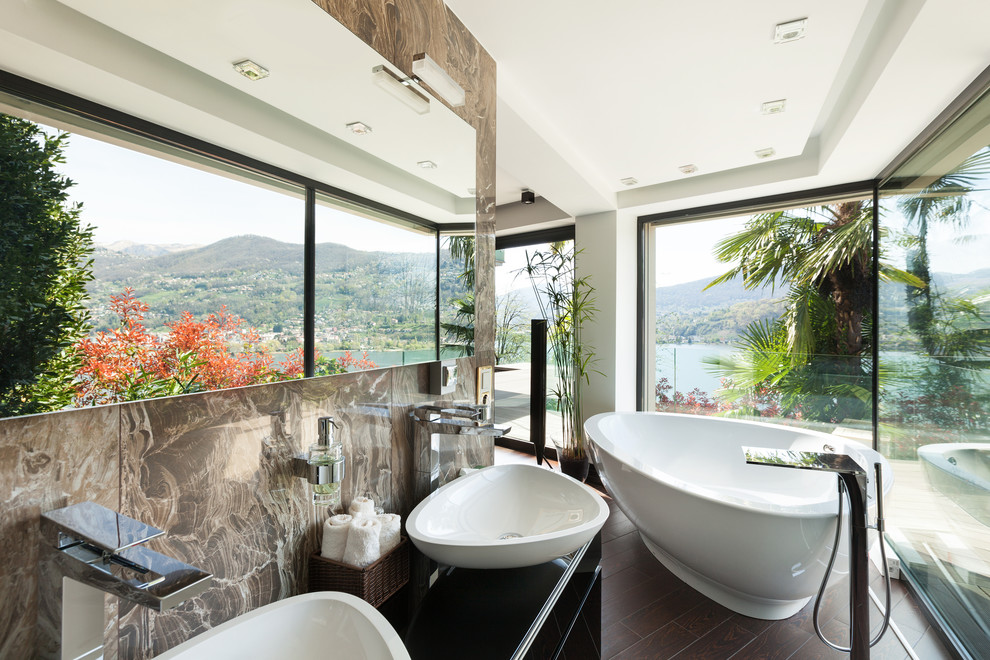 Design ideas for a mid-sized contemporary bathroom in Los Angeles with flat-panel cabinets, black cabinets, a freestanding tub, multi-coloured tile, marble, multi-coloured walls, dark hardwood floors, with a sauna, a vessel sink, wood benchtops and brown floor.