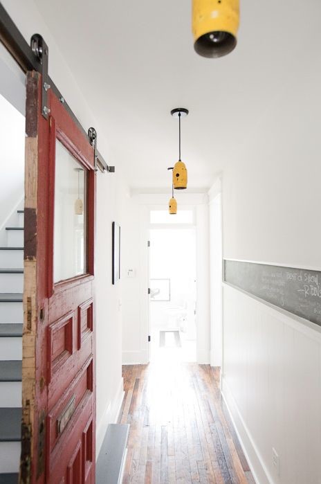 Design ideas for an eclectic hallway in Nashville with white walls and medium hardwood floors.