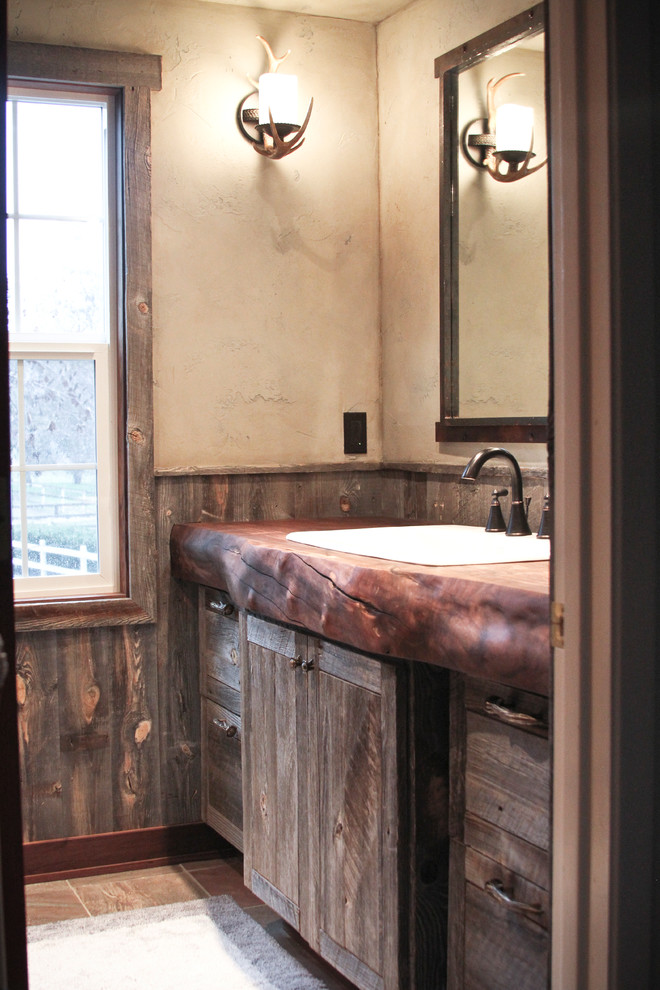 Bathroom - small rustic 3/4 brown tile bathroom idea with wood countertops and beige walls