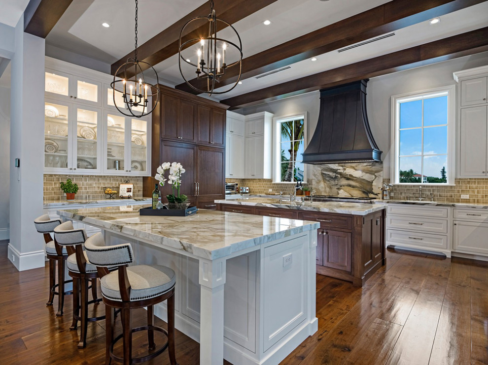Kitchen - transitional kitchen idea in Miami with dark wood cabinets, marble countertops and two islands