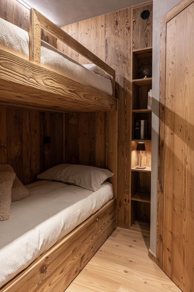 This is an example of a small rustic gender neutral kids' bedroom in Other with brown walls, dark hardwood flooring, brown floors, a wood ceiling and wood walls.