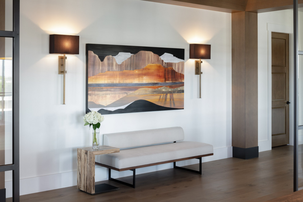 Inspiration for a transitional light wood floor, beige floor and exposed beam hallway remodel in Denver with white walls