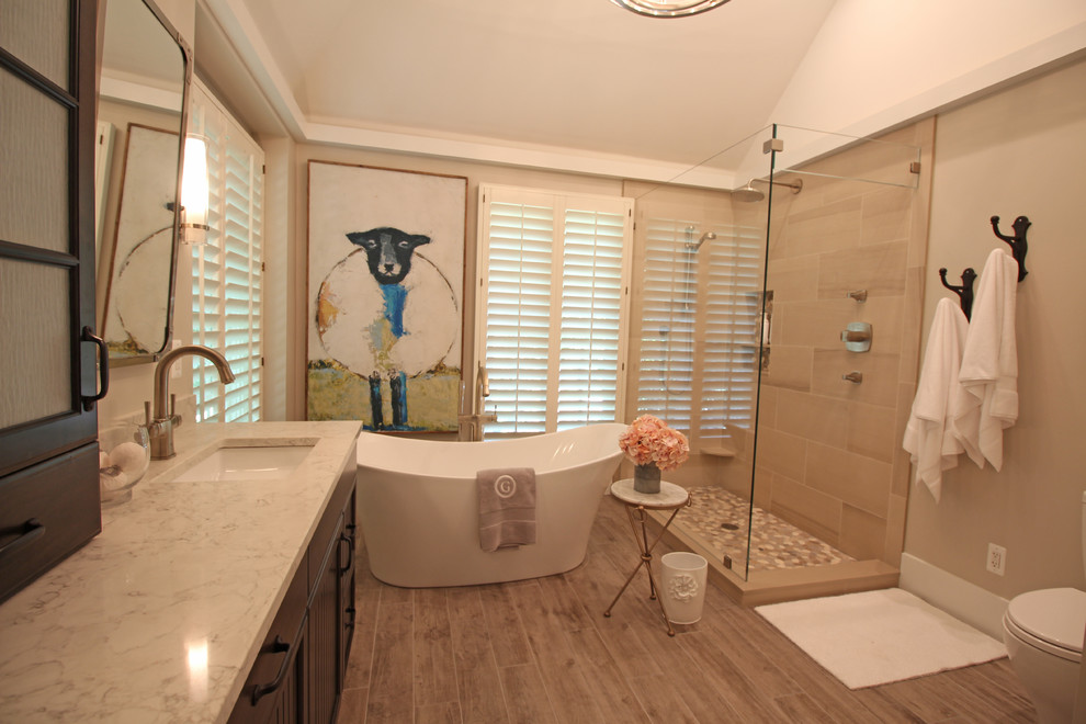 Example of a large transitional master beige tile and ceramic tile ceramic tile and beige floor bathroom design in Detroit with beaded inset cabinets, dark wood cabinets, a two-piece toilet, beige walls, an undermount sink and quartz countertops