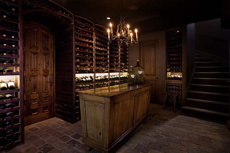 Photo of a mid-sized traditional wine cellar in Orange County with ceramic floors and storage racks.