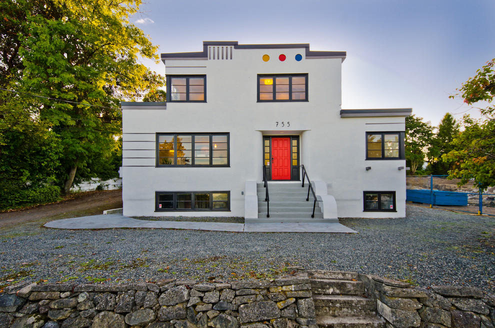 Large modern two-storey stucco grey exterior in Vancouver with a flat roof.
