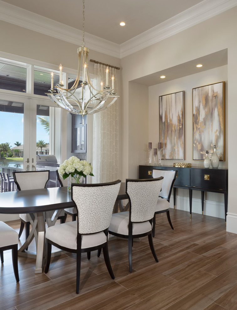 Photo of a large contemporary dining room in Miami with beige walls, dark hardwood floors, no fireplace and brown floor.