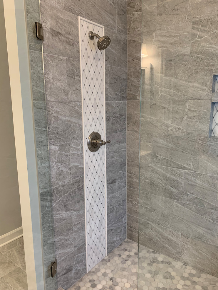 Photo of a mid-sized transitional master bathroom in Atlanta with shaker cabinets, white cabinets, a freestanding tub, a corner shower, a two-piece toilet, gray tile, porcelain tile, grey walls, terra-cotta floors, an undermount sink, engineered quartz benchtops, grey floor, a hinged shower door and white benchtops.