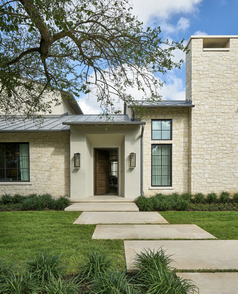 Inspiration for a detached house in Austin with stone cladding, a metal roof and a grey roof.