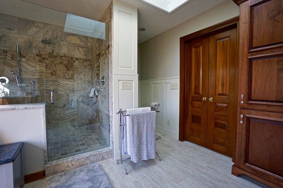 Large contemporary master bathroom in Columbus with furniture-like cabinets, medium wood cabinets, an open shower, a two-piece toilet, multi-coloured tile, stone tile, beige walls, porcelain floors, an undermount sink and granite benchtops.