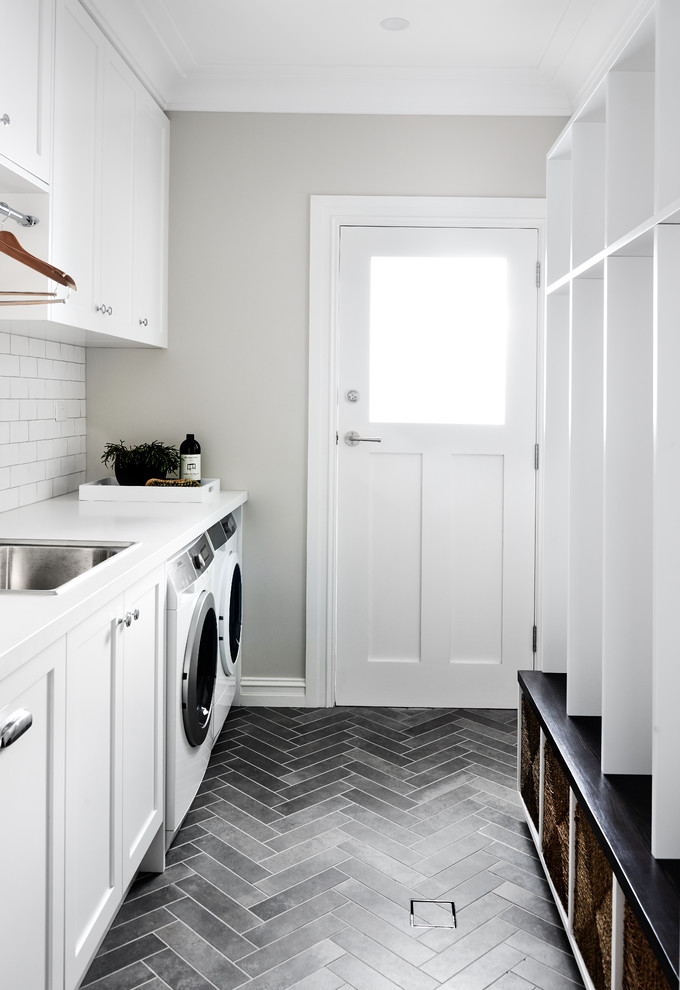 Transitional laundry room in Sydney with a drop-in sink, shaker cabinets, white cabinets, quartz benchtops, porcelain floors, a side-by-side washer and dryer, grey floor and white benchtop.