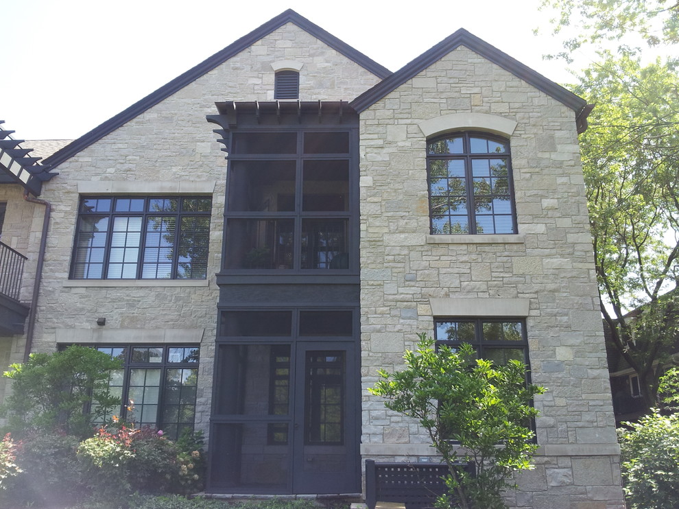Large transitional gray two-story stone gable roof idea in Chicago with a shingle roof
