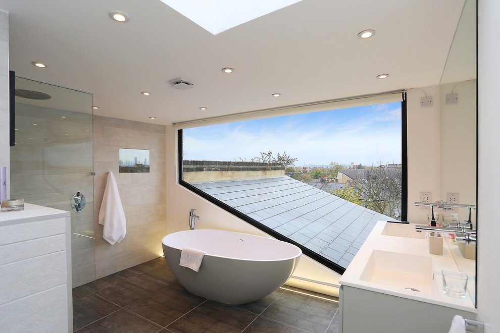 Photo of a contemporary master bathroom in London with an integrated sink, a freestanding tub, an open shower and an open shower.