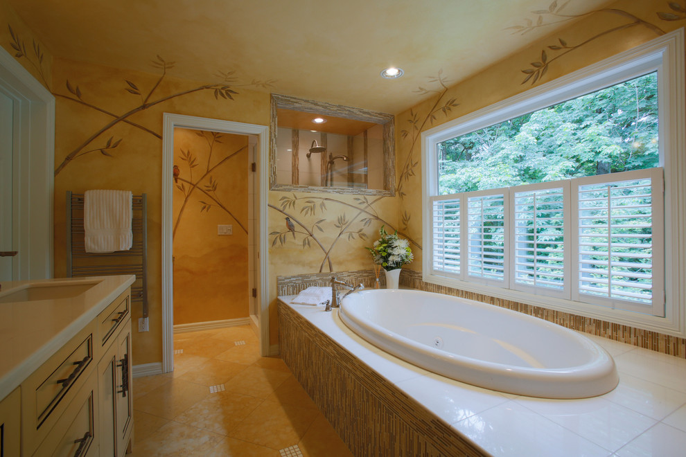Design ideas for a large transitional master bathroom in Portland with recessed-panel cabinets, yellow cabinets, a drop-in tub, an alcove shower, a two-piece toilet, brown tile, gray tile, matchstick tile, yellow walls, travertine floors, an undermount sink and quartzite benchtops.