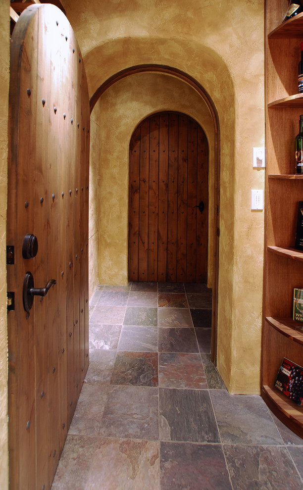 Inspiration for a large traditional wine cellar in Portland with slate floors.