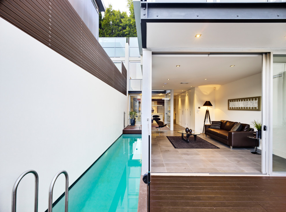 Photo of a contemporary side yard rectangular lap pool in Sydney with decking.