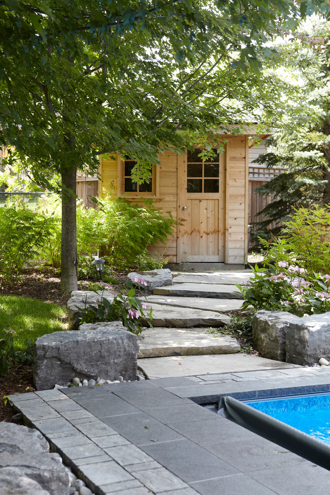 Design ideas for a mid-sized contemporary backyard rectangular lap pool in Toronto with a hot tub and concrete pavers.