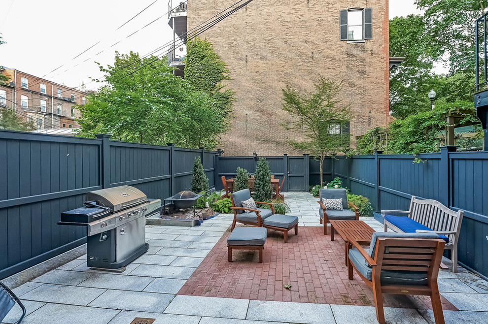 Mid-sized transitional backyard concrete paver patio kitchen photo in Boston with no cover