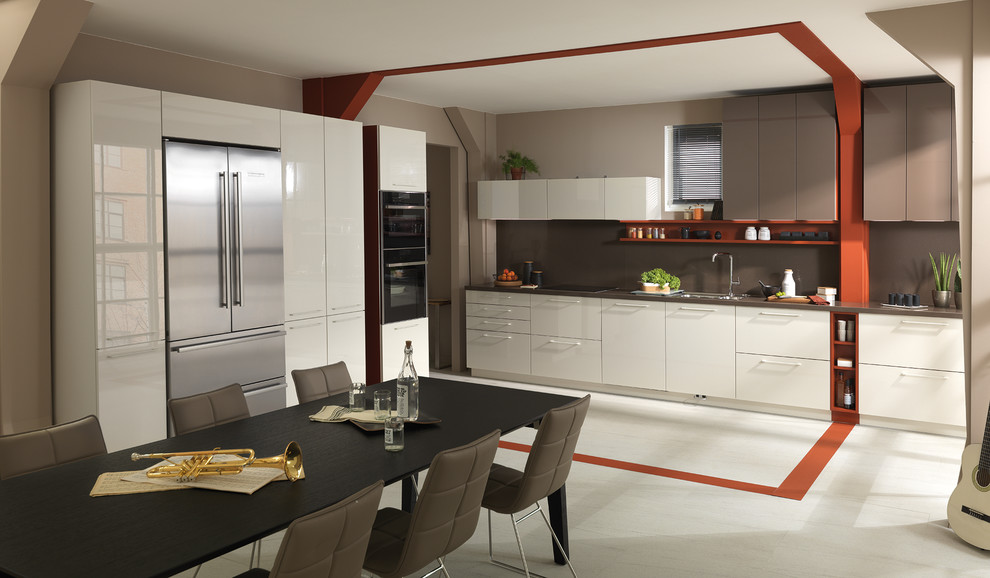 Contemporary single-wall eat-in kitchen in Moscow with a drop-in sink, flat-panel cabinets, white cabinets, quartz benchtops, brown splashback, stone slab splashback, black appliances, porcelain floors and no island.