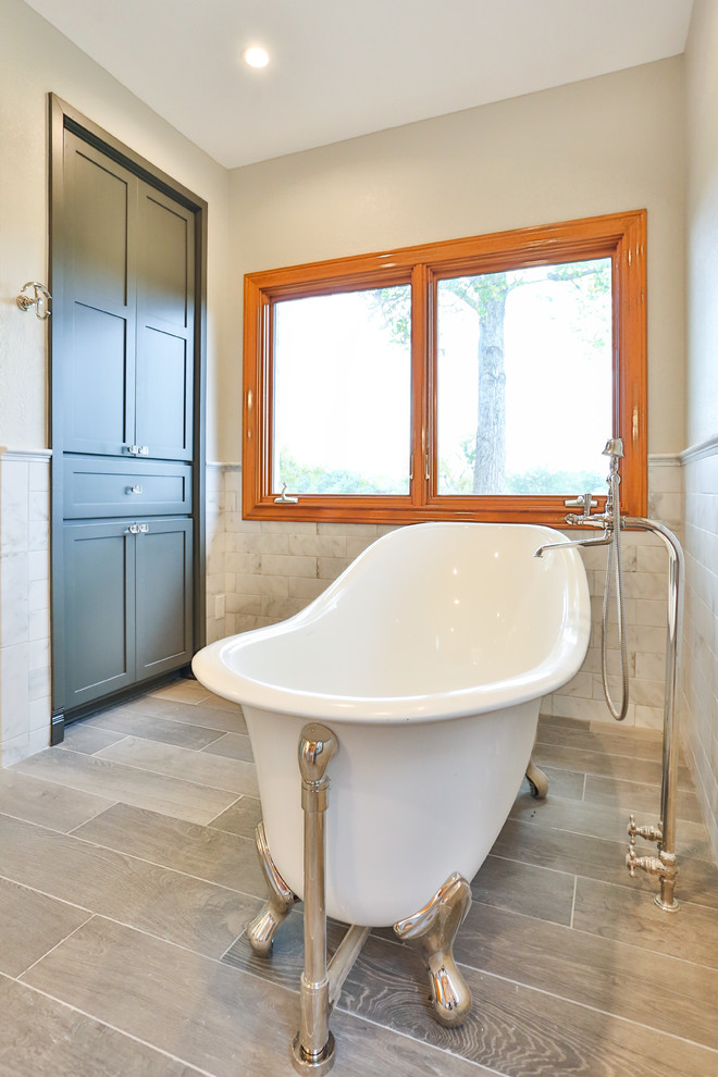 Photo of a large transitional master bathroom in Austin with shaker cabinets, grey cabinets, a claw-foot tub, an alcove shower, a one-piece toilet, gray tile, marble, an undermount sink, solid surface benchtops, a sliding shower screen and yellow benchtops.