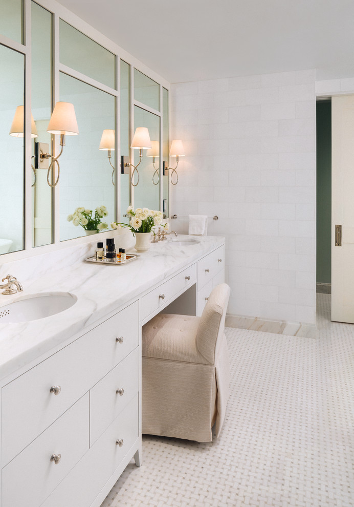 This is an example of a mid-sized transitional master bathroom in New York with white cabinets, white tile, white walls, marble benchtops, white floor, flat-panel cabinets, an undermount sink and white benchtops.