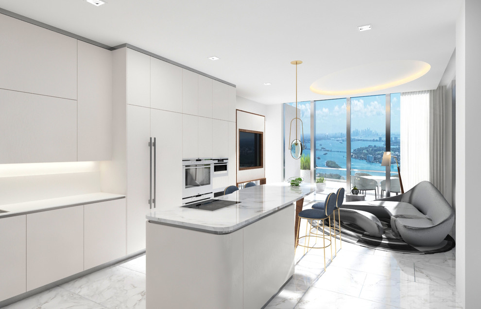 Large modern galley open plan kitchen in Miami with a drop-in sink, flat-panel cabinets, white cabinets, marble benchtops, beige splashback, panelled appliances, marble floors, with island, white floor and beige benchtop.