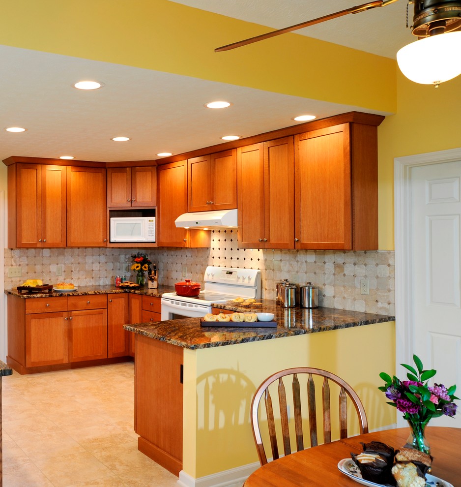 Example of a mid-sized transitional u-shaped limestone floor and beige floor eat-in kitchen design in Cincinnati with a double-bowl sink, shaker cabinets, medium tone wood cabinets, granite countertops, beige backsplash, ceramic backsplash, stainless steel appliances and a peninsula