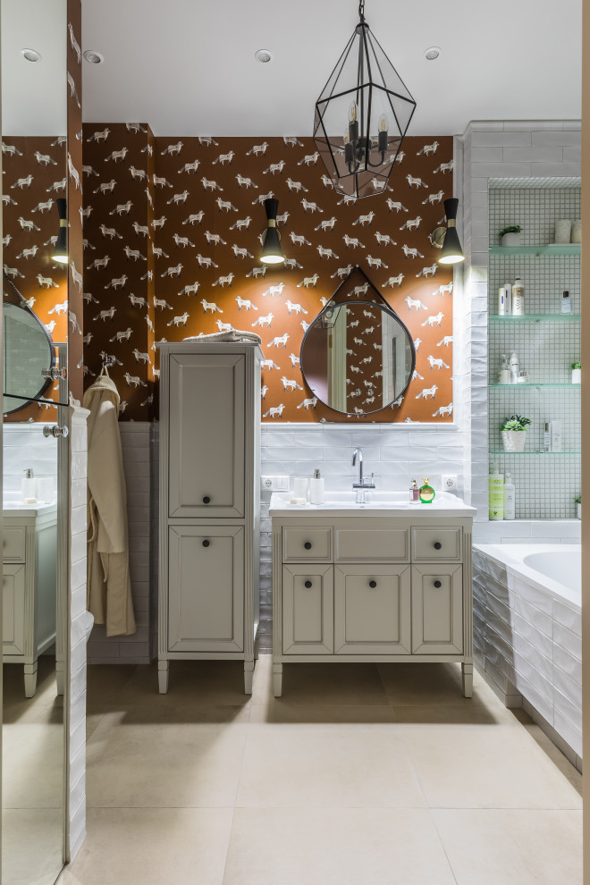 Design ideas for a mid-sized transitional 3/4 bathroom in Other with recessed-panel cabinets, beige cabinets, an alcove tub, white tile, orange walls, an undermount sink, beige floor, white benchtops, a single vanity, a built-in vanity and wallpaper.