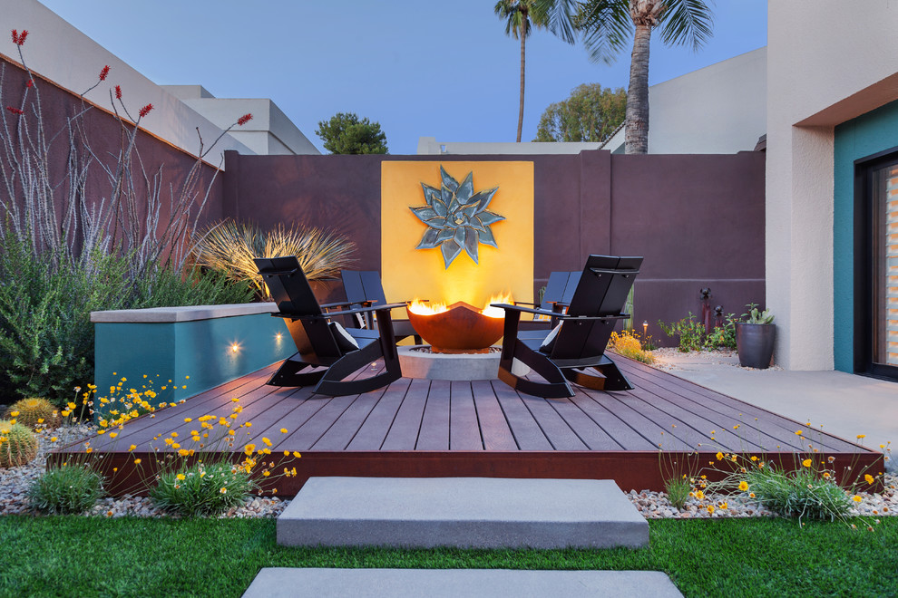 Photo of a large backyard deck in Phoenix with a fire feature and no cover.