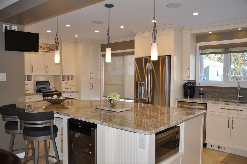 Large transitional l-shaped ceramic tile open concept kitchen photo in Ottawa with an undermount sink, shaker cabinets, beige cabinets, granite countertops, glass tile backsplash, stainless steel appliances and an island