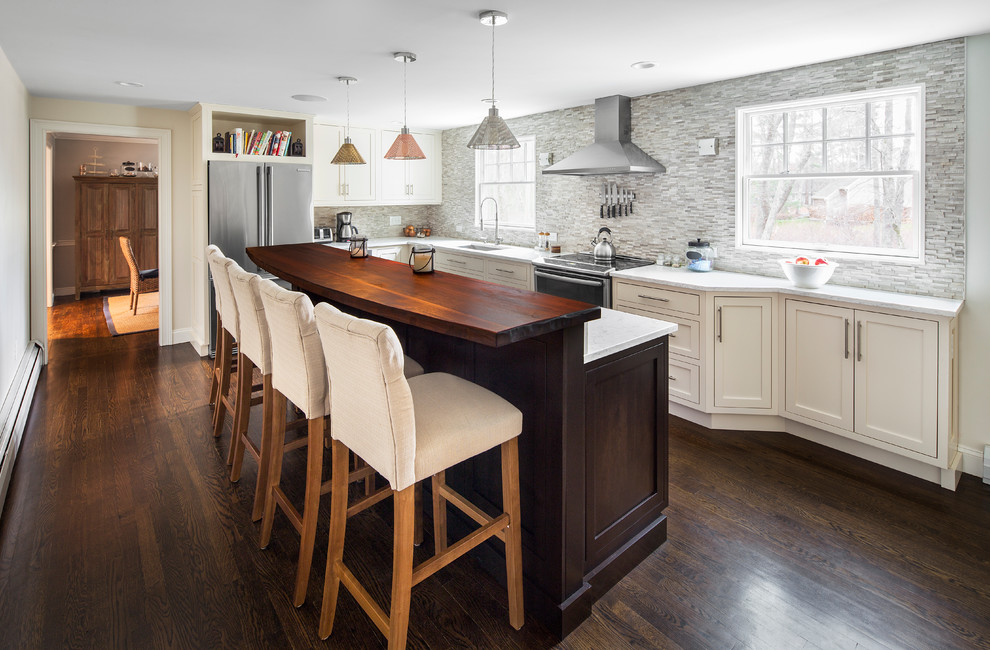 This is an example of a large transitional l-shaped separate kitchen in Boston with an undermount sink, shaker cabinets, white cabinets, marble benchtops, grey splashback, stone tile splashback, stainless steel appliances, dark hardwood floors and with island.