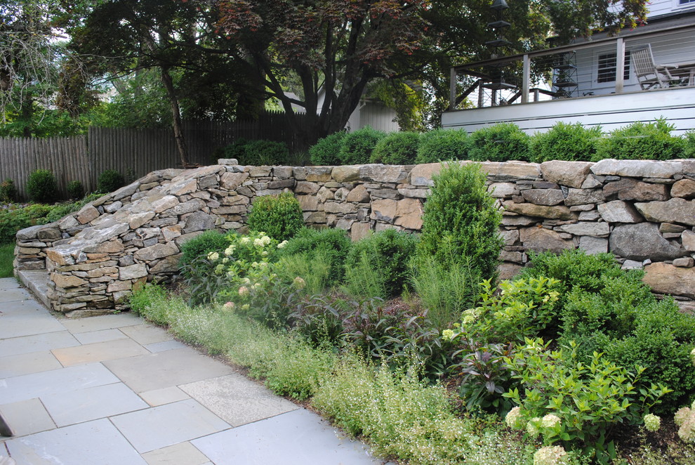 Inspiration for a mid-sized traditional partial sun backyard stone formal garden in Sacramento for summer.