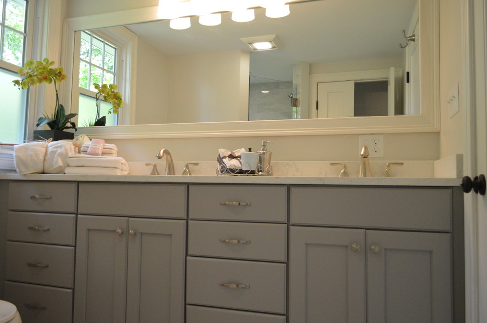 Mid-sized transitional master beige tile and cement tile bathroom photo in Boston with raised-panel cabinets, dark wood cabinets, a hot tub, an undermount sink, quartz countertops and beige countertops