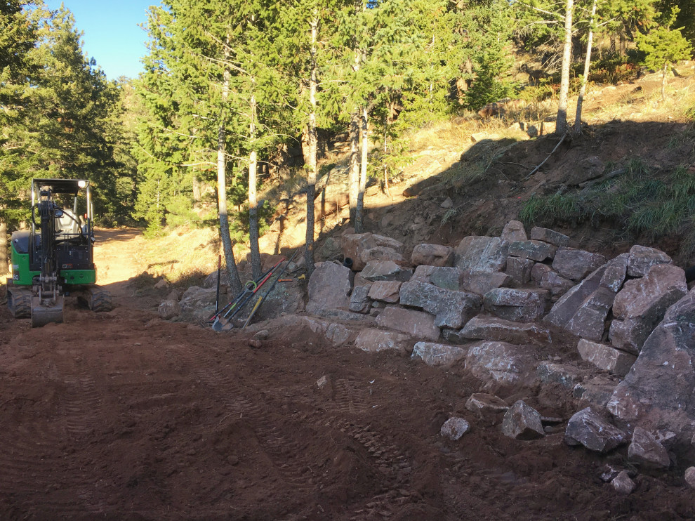Design ideas for a huge rustic hillside retaining wall landscape in Denver.