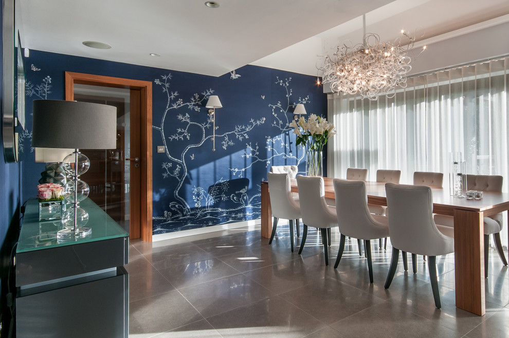 Photo of a large transitional dining room in London with blue walls.