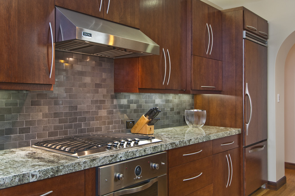 Transitional separate kitchen in San Francisco with panelled appliances, flat-panel cabinets, dark wood cabinets, grey splashback and subway tile splashback.
