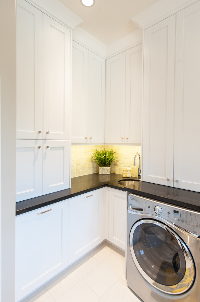 Example of a large transitional u-shaped white floor utility room design in Salt Lake City with an undermount sink, shaker cabinets, white cabinets, granite countertops, white walls and a side-by-side washer/dryer
