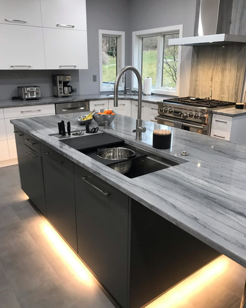 This is an example of a contemporary l-shaped eat-in kitchen in Other with an undermount sink, flat-panel cabinets, quartzite benchtops, stainless steel appliances, with island and blue benchtop.