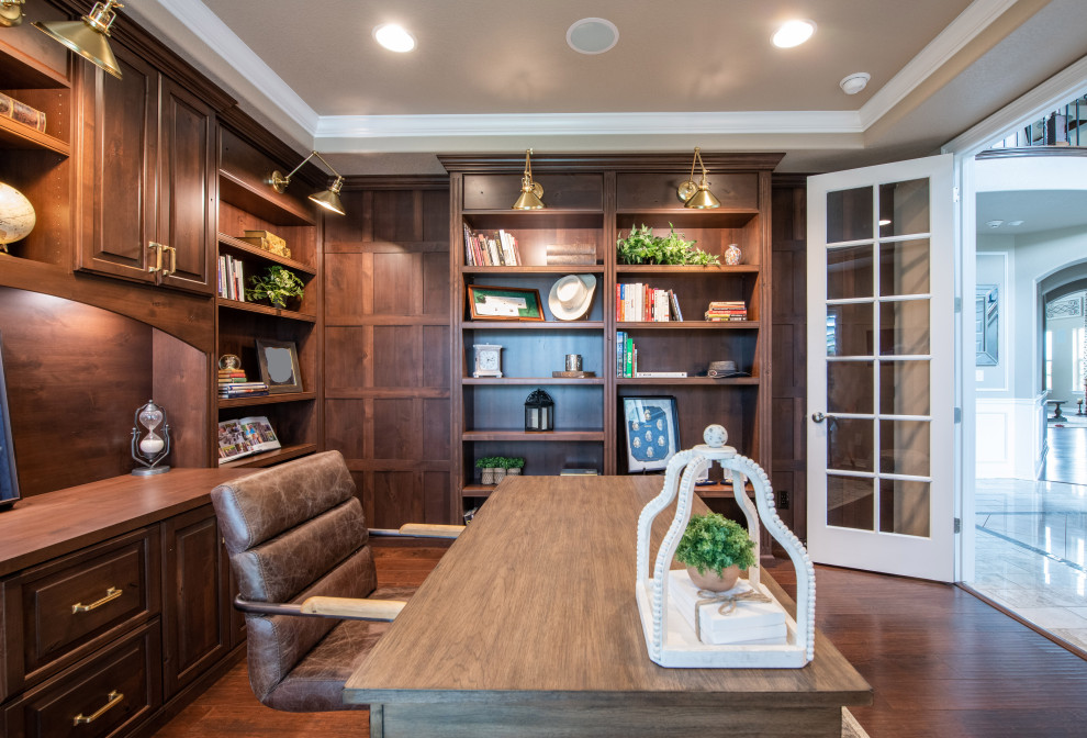 Study room - mid-sized traditional freestanding desk medium tone wood floor and brown floor study room idea in Denver with beige walls